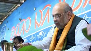 Union Home Minister and BJP leader Amit Shah having food at the house of a tribal family at Chaturthi village, in Bankura, West Bengal.(ANI) Union Home Minister and BJP leader Amit Shah having food at the house of a tribal family at Chaturthi village, in Bankura, West Bengal.(ANI)