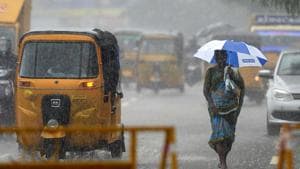 A woman walks under an umbrella during heavy rains in Chennai on Tuesday as Cyclone Nivar approaches the southeastern coast. The Indian Meteorological Department has said Cyclone Nivar is set to cross the coasts of Tamil Nadu and Puducherry as a “very severe cyclonic storm” late on Wednesday.(AFP Photo)