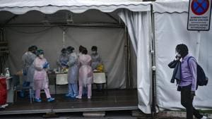 Mbaye Babacar Diouf, right, walks by a special coronavirus checkpoint, at Basurto hospital, in Bilbao, northern Spain, Wednesday, Nov. 18, 2020. Mbaye Babacar Diouf's life as a migrant in Europe took a turn for the better when he was adopted in Spain at the age of 28. That enabled him to pay his debts to human traffickers, study nursing and find a job at a Spanish hospital. Now he's giving back to the community. In a Bilbao hospital he cares for COVID-19 patients.(AP) Mbaye Babacar Diouf, right, walks by a special coronavirus checkpoint, at Basurto hospital, in Bilbao, northern Spain, Wednesday, Nov. 18, 2020. Mbaye Babacar Diouf's life as a migrant in Europe took a turn for the better when he was adopted in Spain at the age of 28. That enabled him to pay his debts to human traffickers, study nursing and find a job at a Spanish hospital. Now he's giving back to the community. In a Bilbao hospital he cares for COVID-19 patients.(AP)