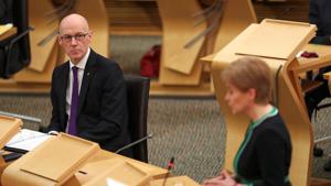 Scottish Deputy First Minister and Cabinet Secretary for Education John Swinney looks at First Minister Nicola Sturgeon as she makes a statement to the Scottish Parliament.(Reuters) Scottish Deputy First Minister and Cabinet Secretary for Education John Swinney looks at First Minister Nicola Sturgeon as she makes a statement to the Scottish Parliament.(Reuters)