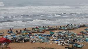 Boats are seen parked on deserted Marina beach during rains before Cyclone Nivar's landfall, in Chennai.(REUTERS) Boats are seen parked on deserted Marina beach during rains before Cyclone Nivar's landfall, in Chennai.(REUTERS)