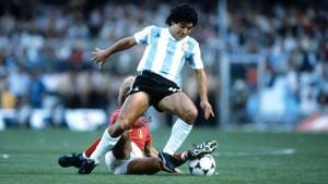 Diego Maradona tackles the ball past a defender.(Getty Images) Diego Maradona tackles the ball past a defender.(Getty Images)