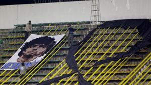 Workers install a banner with the image of Diego Maradona at the Norberto Tomaghello stadium before a Copa Sudamericana Soccer match between Argentina's Defensa y Justicia and Brazil's Vasco Da Gama in Buenos Aires, Argentina, Thursday, Nov. 26, 2020. The Argentine soccer great who was among the best players ever and who led his country to the 1986 World Cup title died from a heart attack at his home Wednesday, at the age of 60. (Daniel Jayo/Pool via AP )(AP) Workers install a banner with the image of Diego Maradona at the Norberto Tomaghello stadium before a Copa Sudamericana Soccer match between Argentina's Defensa y Justicia and Brazil's Vasco Da Gama in Buenos Aires, Argentina, Thursday, Nov. 26, 2020. The Argentine soccer great who was among the best players ever and who led his country to the 1986 World Cup title died from a heart attack at his home Wednesday, at the age of 60. (Daniel Jayo/Pool via AP )(AP)