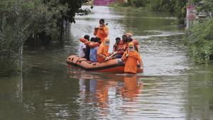Over 1,100 trees were uprooted, besides the loss of cattle and damage to huts, authorities said. People waded through neck- deep in some places where first responders used inflated boats to rescue families to safer locations.(PTI) Over 1,100 trees were uprooted, besides the loss of cattle and damage to huts, authorities said. People waded through neck- deep in some places where first responders used inflated boats to rescue families to safer locations.(PTI)