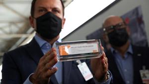FILE PHOTO: Brazil's Sao Paulo state governor, Joao Doria, and director of Instituto Butantan, Dimas Tadeu Covas, hold boxes of the China's Sinovac vaccine against the coronavirus disease (COVID-19) as a cargo plane containing the vaccines arrives at Sao Paulo International Airport in Guarulhos, Brazil November 19, 2020. REUTERS/Amanda Perobelli/File Photo(REUTERS) FILE PHOTO: Brazil's Sao Paulo state governor, Joao Doria, and director of Instituto Butantan, Dimas Tadeu Covas, hold boxes of the China's Sinovac vaccine against the coronavirus disease (COVID-19) as a cargo plane containing the vaccines arrives at Sao Paulo International Airport in Guarulhos, Brazil November 19, 2020. REUTERS/Amanda Perobelli/File Photo(REUTERS)