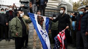 Protesters burn the U.S. and Israeli flags during a demonstration against the the killing of Mohsen Fakhrizadeh.(REUTERS) Protesters burn the U.S. and Israeli flags during a demonstration against the the killing of Mohsen Fakhrizadeh.(REUTERS)