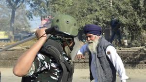 A security person attempts to baton charge a farmer as protestors cross Singhu Border during 'Delhi Chalo' march against the new farm laws, in New Delhi on Friday. (PTI Photo/Ravi Choudhary)(PTI) A security person attempts to baton charge a farmer as protestors cross Singhu Border during 'Delhi Chalo' march against the new farm laws, in New Delhi on Friday. (PTI Photo/Ravi Choudhary)(PTI)