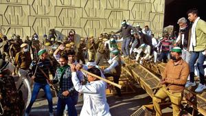 Members of the Bharatiya Kisan Union break through barricades at UP Gate, at the Ghaziabad border with Delhi. Members of the Bharatiya Kisan Union break through barricades at UP Gate, at the Ghaziabad border with Delhi.