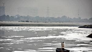 A man rows a boat in the heavily polluted waters of the Yamuna at Kalindi Kunj.