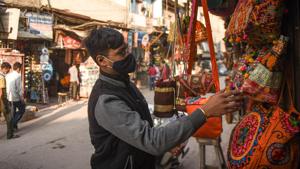 A man looks at bags displayed outside a shop, at Paharganj Market, in New Delhi.(Sanchit Khanna/HT PHOTO) A man looks at bags displayed outside a shop, at Paharganj Market, in New Delhi.(Sanchit Khanna/HT PHOTO)