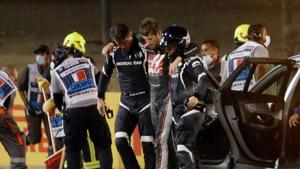 Haas' Romain Grosjean walks away from the crash scene with the help of medical officers after crashing out of the race.(Pool via REUTERS) Haas' Romain Grosjean walks away from the crash scene with the help of medical officers after crashing out of the race.(Pool via REUTERS)