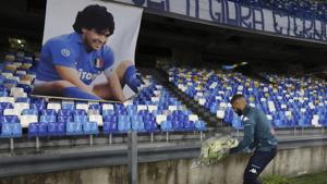 Naples:Napoli's Lorenzo Insigne lays a bouquet of flowers under a photo of Diego Armando Maradona exposed at the San Paolo stadium, Sunday, Nov. 29, 2020, prior to the Italian Serie A soccer match between Napoli and Roma, in Naples, Italy. AP/PTI Photo(AP30-11-2020_000004A)(AP) Naples:Napoli's Lorenzo Insigne lays a bouquet of flowers under a photo of Diego Armando Maradona exposed at the San Paolo stadium, Sunday, Nov. 29, 2020, prior to the Italian Serie A soccer match between Napoli and Roma, in Naples, Italy. AP/PTI Photo(AP30-11-2020_000004A)(AP)