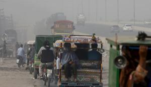 People travel on a road as smog envelops Lahore, Pakistan.(AP) People travel on a road as smog envelops Lahore, Pakistan.(AP)