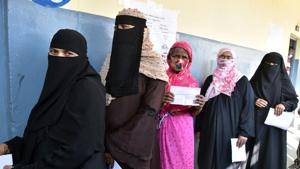Voters stand in a queue holding their voter Ids at a polling booth during the GHMC Election, in Hyderabad on Tuesday.(ANI) Voters stand in a queue holding their voter Ids at a polling booth during the GHMC Election, in Hyderabad on Tuesday.(ANI)
