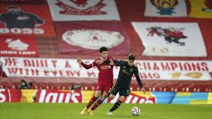 Liverpool's Curtis Jones, left, challenges Ajax's Nicolas Tagliafico during the Champions League group D soccer match between Liverpool and Ajax at Anfield stadium in Liverpool, England, Tuesday, Dec. 1, 2020. (AP Photo/Jon Super, Pool)(AP) Liverpool's Curtis Jones, left, challenges Ajax's Nicolas Tagliafico during the Champions League group D soccer match between Liverpool and Ajax at Anfield stadium in Liverpool, England, Tuesday, Dec. 1, 2020. (AP Photo/Jon Super, Pool)(AP)
