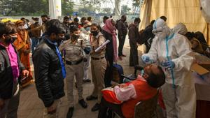 A health worker in PPE coveralls collects swab samples for Covid-19 test, at Anand Vihar Bus Terminal in New Delhi, India, on Wednesday, December 2, 2020.(Amal KS/HT photo) A health worker in PPE coveralls collects swab samples for Covid-19 test, at Anand Vihar Bus Terminal in New Delhi, India, on Wednesday, December 2, 2020.(Amal KS/HT photo)