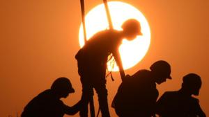 Labourers at work on a construction site against the backdrop of a setting sun on Dwarka Expressway near Sector-94, in Gurugram.(Parveen Kumar/Hindustan Times) Labourers at work on a construction site against the backdrop of a setting sun on Dwarka Expressway near Sector-94, in Gurugram.(Parveen Kumar/Hindustan Times)