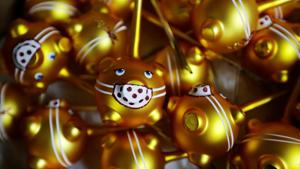 Glass Christmas tree decorations shaped like pigs.(REUTERS) Glass Christmas tree decorations shaped like pigs.(REUTERS)