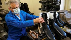 Romanian cobbler Grigore Lup presents a pair of oversized winter boots after finishing them, in his workshop in Cluj-Napoca, Romania,(REUTERS) Romanian cobbler Grigore Lup presents a pair of oversized winter boots after finishing them, in his workshop in Cluj-Napoca, Romania,(REUTERS)