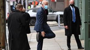 US President-elect Joe Biden playfully shows off his boot as he arrives at The Queen in Wilmington, US.(AFP)