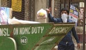 A person throws garbage into a collection vehicle in Jahangirpuri, New Delhi.(Sanchit Khanna/HT FILE PHOTO)
