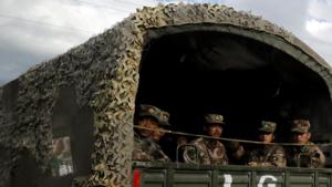 Chinese soldiers of the People's Liberation Army (PLA) sit on the back of a truck on the highway to Nyingchi, Tibet Autonomous Region, China.(REUTERS) Chinese soldiers of the People's Liberation Army (PLA) sit on the back of a truck on the highway to Nyingchi, Tibet Autonomous Region, China.(REUTERS)