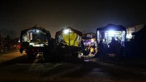 Farmers take rest on tractor-trolleys at night during their ongoing protest against the Centre's new farm laws, at Singhu border in New Delhi, Saturday, Dec. 5, 2020.(PTI photo)