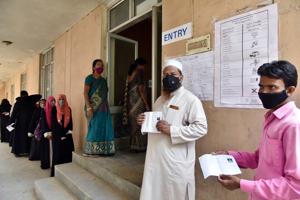 Voters show their Voter ID slips as they stand in a queue to vote for the GHMC election, in Hyderabad on Thursday.(ANI File Photo) Voters show their Voter ID slips as they stand in a queue to vote for the GHMC election, in Hyderabad on Thursday.(ANI File Photo)