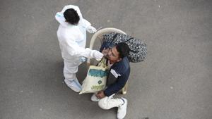A medical worker collects a swab sample for coronavirus test at IFFCO Chowk, in Gurugram, on December 5.(HT file) A medical worker collects a swab sample for coronavirus test at IFFCO Chowk, in Gurugram, on December 5.(HT file)