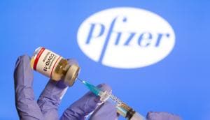 A woman holds a small bottle labelled with a "Coronavirus COVID-19 Vaccine" sticker and a medical syringe in front of displayed Pfizer logo.(Reuters File Photo) A woman holds a small bottle labelled with a "Coronavirus COVID-19 Vaccine" sticker and a medical syringe in front of displayed Pfizer logo.(Reuters File Photo)