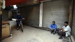 People sit in front of closed shops at Ballimaran market in the wake of Bharat Bandh called by protesting farmers against new farm laws, in New Delhi, India, on Tuesday, December 8, 2020.(Sanjeev Verma/HT photo) People sit in front of closed shops at Ballimaran market in the wake of Bharat Bandh called by protesting farmers against new farm laws, in New Delhi, India, on Tuesday, December 8, 2020.(Sanjeev Verma/HT photo)