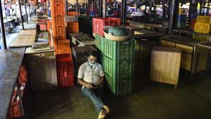 A vendor rests in the deserted Dadar wholesale flower market of Mumbai during Bharat Bandh on Tuesday.(PTI) A vendor rests in the deserted Dadar wholesale flower market of Mumbai during Bharat Bandh on Tuesday.(PTI)