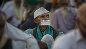 A farmer's mouth is covered with a tape which reads, "Walking on the footsteps of Gandhi, I am on hunger strike", as farmers protesting against new farm laws block a major highway at the Delhi-Uttar Pradesh state border, India, Wednesday, Dec. 9, 2020.(AP photo) A farmer's mouth is covered with a tape which reads, "Walking on the footsteps of Gandhi, I am on hunger strike", as farmers protesting against new farm laws block a major highway at the Delhi-Uttar Pradesh state border, India, Wednesday, Dec. 9, 2020.(AP photo)