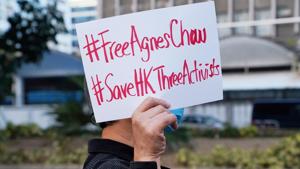 A supporter holds up a sign after the sentencing of pro-democracy activists Joshua Wong, Agnes Chow and Ivan Lam, at West Kowloon Magistrates' Courts in Hong Kong, China.(Reuters) A supporter holds up a sign after the sentencing of pro-democracy activists Joshua Wong, Agnes Chow and Ivan Lam, at West Kowloon Magistrates' Courts in Hong Kong, China.(Reuters)