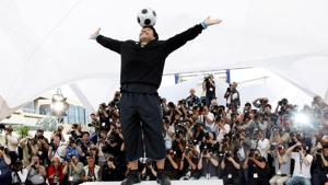 FILE PHOTO: Former soccer star Diego Maradona balances a ball on his head during a photocall for FILE PHOTO: Former soccer star Diego Maradona balances a ball on his head during a photocall for