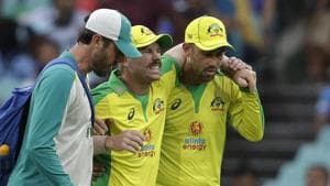 Australia's David Warner, centre, is assisted from the field after injuring himself while fielding during the one day international cricket match between India and Australia at the Sydney Cricket Ground in Sydney, Australia.(AP)
