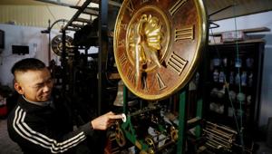 Clocks collector Pham Van Thuoc shows an old church clock from Europe at his home in Thai Binh province, Vietnam.(REUTERS) Clocks collector Pham Van Thuoc shows an old church clock from Europe at his home in Thai Binh province, Vietnam.(REUTERS)