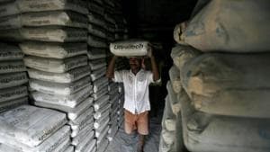 A labourer carries a sack of cement inside a shop in Agartala, capital of Tripura.(REUTERS) A labourer carries a sack of cement inside a shop in Agartala, capital of Tripura.(REUTERS)