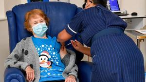 Margaret Keenan, 90, is the first patient in Britain to receive the Pfizer/BioNtech Covid-19 vaccine at University Hospital, administered by nurse May Parsons, at the start of the largest ever immunisation programme in the British history, in Coventry, England on December 8. (Jacob King / Pool via REUTERS) Margaret Keenan, 90, is the first patient in Britain to receive the Pfizer/BioNtech Covid-19 vaccine at University Hospital, administered by nurse May Parsons, at the start of the largest ever immunisation programme in the British history, in Coventry, England on December 8. (Jacob King / Pool via REUTERS)
