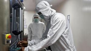 An employee in personal protective equipment (PPE) removes vials of AstraZeneca's COVISHIELD, coronavirus disease (COVID-19) vaccine from a visual inspection machine inside a lab at Serum Institute of India, Pune.(REUTERS) An employee in personal protective equipment (PPE) removes vials of AstraZeneca's COVISHIELD, coronavirus disease (COVID-19) vaccine from a visual inspection machine inside a lab at Serum Institute of India, Pune.(REUTERS)