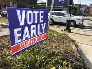 A sign in an Atlanta neighborhood urges people to vote early in Georgia's two US Senate races.(AP) A sign in an Atlanta neighborhood urges people to vote early in Georgia's two US Senate races.(AP)