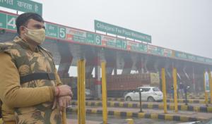 A policeman at Chajjarsi toll plaza, where farmers are camped in protest against three new farm laws, in Hapur district of Uttar Pradesh on Saturday.(Sakib Ali/HT Photo) A policeman at Chajjarsi toll plaza, where farmers are camped in protest against three new farm laws, in Hapur district of Uttar Pradesh on Saturday.(Sakib Ali/HT Photo)