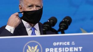 President-elect Joe Biden removes his mask as he arrives to speak after the Electoral College formally elected him as president, Monday at The Queen theater in Wilmington, Delaware.(AP) President-elect Joe Biden removes his mask as he arrives to speak after the Electoral College formally elected him as president, Monday at The Queen theater in Wilmington, Delaware.(AP)
