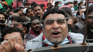A supporter of the Pakistan Democratic Movement (PDM), an alliance of political opposition parties, chants slogans as he attends an anti-government protest rally, in Lahore, Pakistan.(REUTERS) A supporter of the Pakistan Democratic Movement (PDM), an alliance of political opposition parties, chants slogans as he attends an anti-government protest rally, in Lahore, Pakistan.(REUTERS)