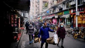 People wearing protective masks walk at a street market almost a year after the start of the coronavirus disease (Covid-19) outbreak, in Wuhan, Hubei province, China.(REUTERS) People wearing protective masks walk at a street market almost a year after the start of the coronavirus disease (Covid-19) outbreak, in Wuhan, Hubei province, China.(REUTERS)