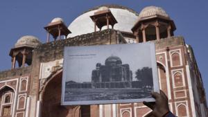 A person holds an old photograph of the Tomb of Abdur Rahim Khan-i-Khanan also known as Rahim's Tomb, to draw comparison after the completion of its restoration work, near Nizamuddin, in New Delhi on Wednesday.(Vipin Kumar/HT PHOTO) A person holds an old photograph of the Tomb of Abdur Rahim Khan-i-Khanan also known as Rahim's Tomb, to draw comparison after the completion of its restoration work, near Nizamuddin, in New Delhi on Wednesday.(Vipin Kumar/HT PHOTO)