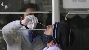 A health worker collects a swab sample from a woman for Covid-19 test, at Sector 30 District Hospital, in Noida.(Sunil Ghosh/HT Photo) A health worker collects a swab sample from a woman for Covid-19 test, at Sector 30 District Hospital, in Noida.(Sunil Ghosh/HT Photo)