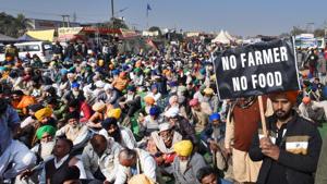 A farmer holds a banner during a protest against the new farm laws, at Singhu (Delhi-Haryana border) near New Delhi on Wednesday.(Ajay Aggarwal /HT PHOTO) A farmer holds a banner during a protest against the new farm laws, at Singhu (Delhi-Haryana border) near New Delhi on Wednesday.(Ajay Aggarwal /HT PHOTO)