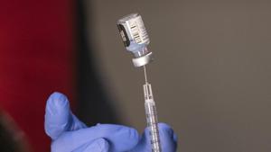 Pharmacist Ron Simono fills a syringe with a dose of the Pfizer-BioNtech Covid-19 vaccine during a vaccine clinic on Wednesday.(AP Photo) Pharmacist Ron Simono fills a syringe with a dose of the Pfizer-BioNtech Covid-19 vaccine during a vaccine clinic on Wednesday.(AP Photo)
