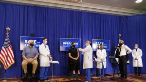 Karen Pence, seated center, receives a Pfizer-BioNTech Covid-19 vaccine shot at the Eisenhower Executive Office Building on the White House complex in Washington. Vice President Mike Pence and US Surgeon General Jerome Adams also participated.(AP) Karen Pence, seated center, receives a Pfizer-BioNTech Covid-19 vaccine shot at the Eisenhower Executive Office Building on the White House complex in Washington. Vice President Mike Pence and US Surgeon General Jerome Adams also participated.(AP)
